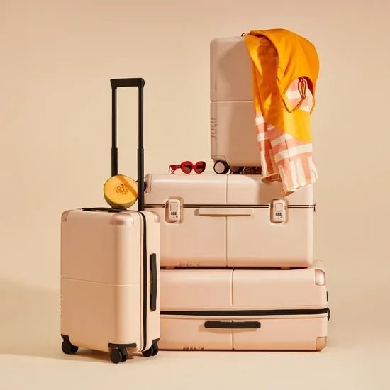 Traveller walking through a sunlit city with a suitcase